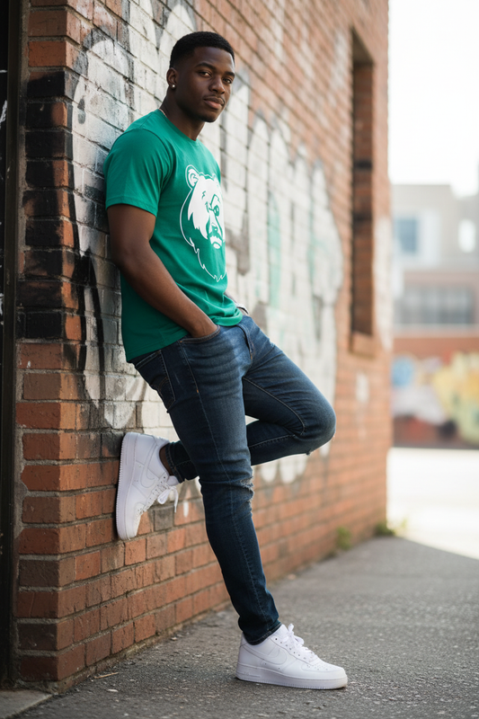 Black male model leaning against wall in green OG Bear Tee