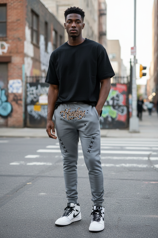Slim Black male in Husky Gray Leopard Jogger with white Air Jordan 1s