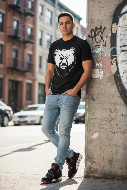Slim Latino man in black OG Bear Tee with Jordan 4s
